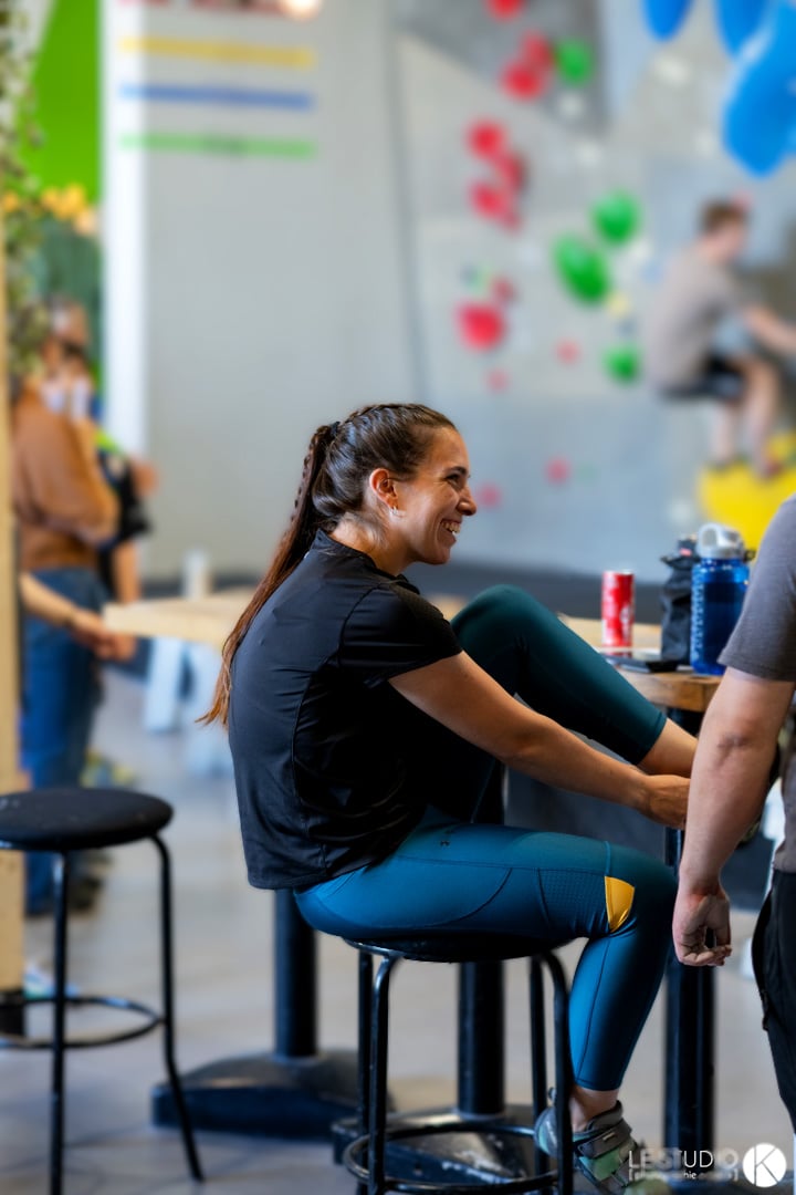 Climber sitting at the gym tables, mid-conversation